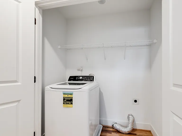Laundry area with side-by-side washer/dryer and storage above