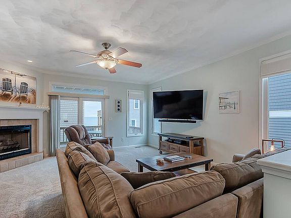 2nd level living room with large TV with cable, fireplace, and balcony overlooking the ocean, and a gas grill!