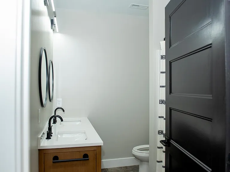 Primary bathroom - double vanity, bathtub and toilet