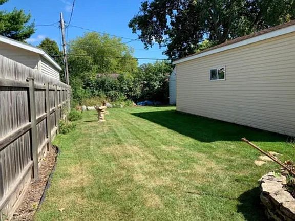 Private backyard with built in bonfire pit.