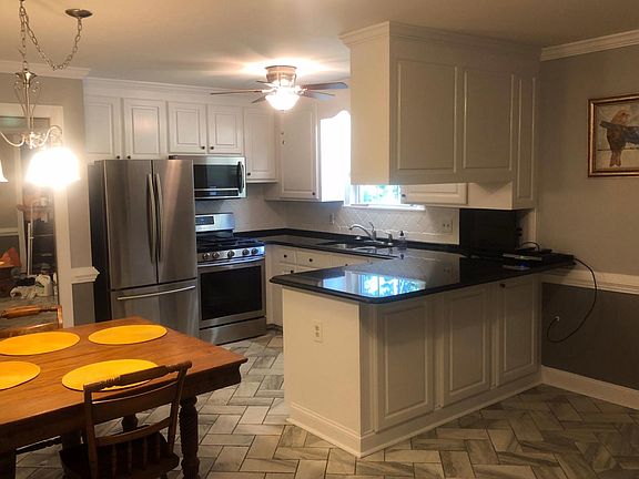 Eat in kitchen with ceiling height cabinets. New light fixtures.