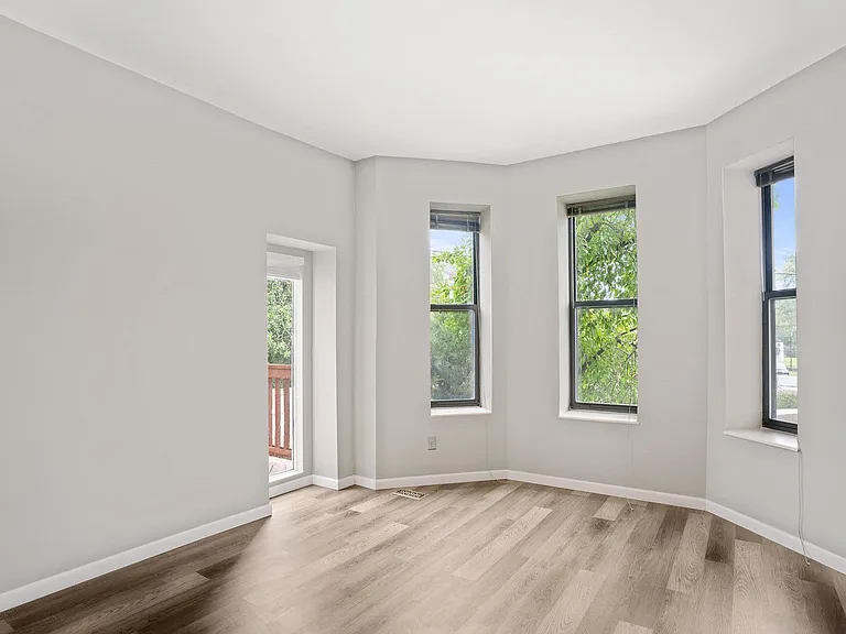 Living room with private deck; off-street parking in front