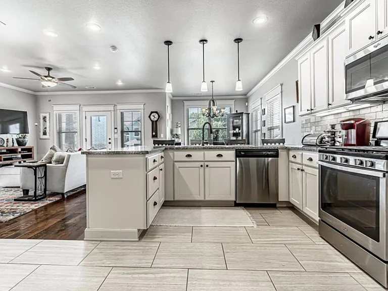 Kitchen with tile flooring, granite counters, SS appliances and seating for 4 at count top