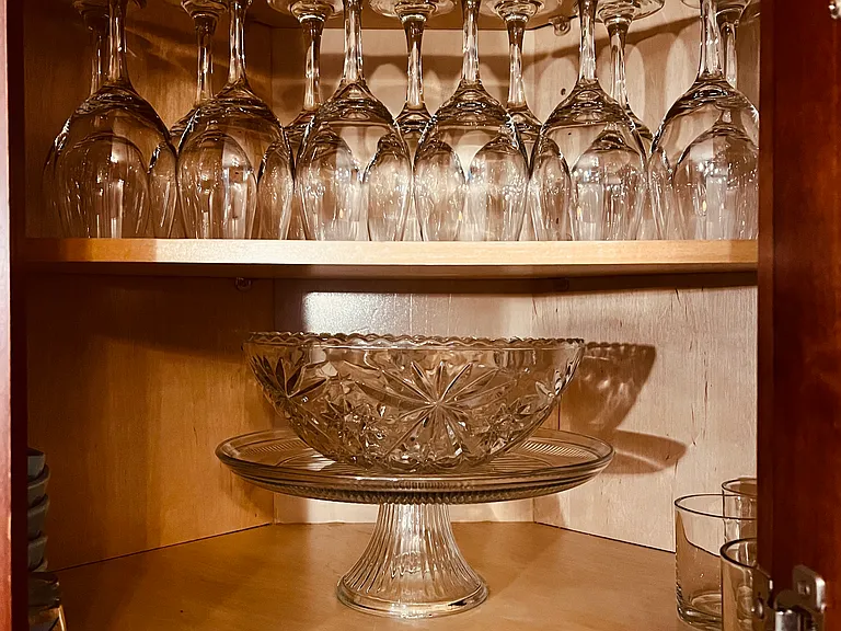 Glassware, dishes, cookware and more in fully loaded kitchen.