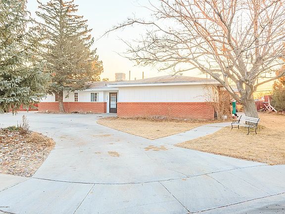 Right-side entrance leads to a spacious driveway with parking for 10+ vehicles, offering plenty of room for a camper, boat, or other recreational vehicles. A sidewalk from the driveway provides convenient access to the kitchen entrance.