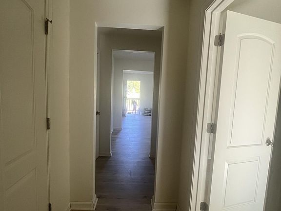 Hallway to room and bathroom two closets in the hall.