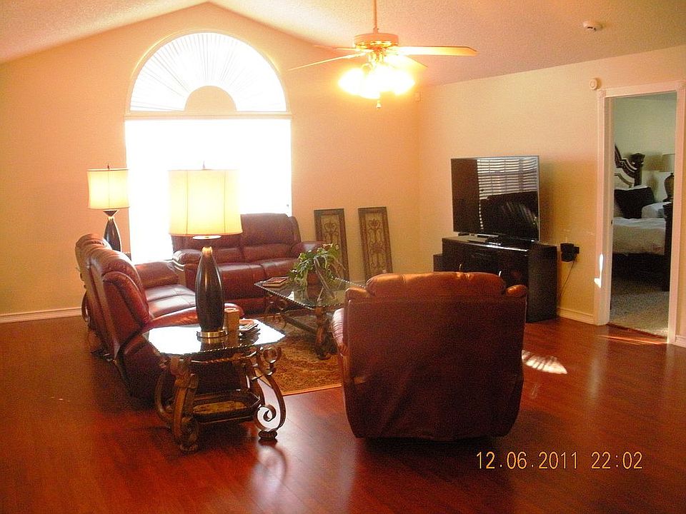 Living room has floor to ceiling windows
