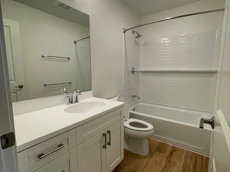 Main bathroom with brand new flooring, great counter space plus a medicine cabinet for toiletry storage
