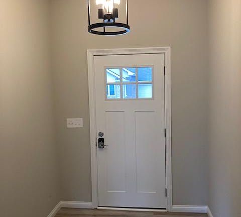 Open Hallway with Modern Light Fixture and Combination Door Lock