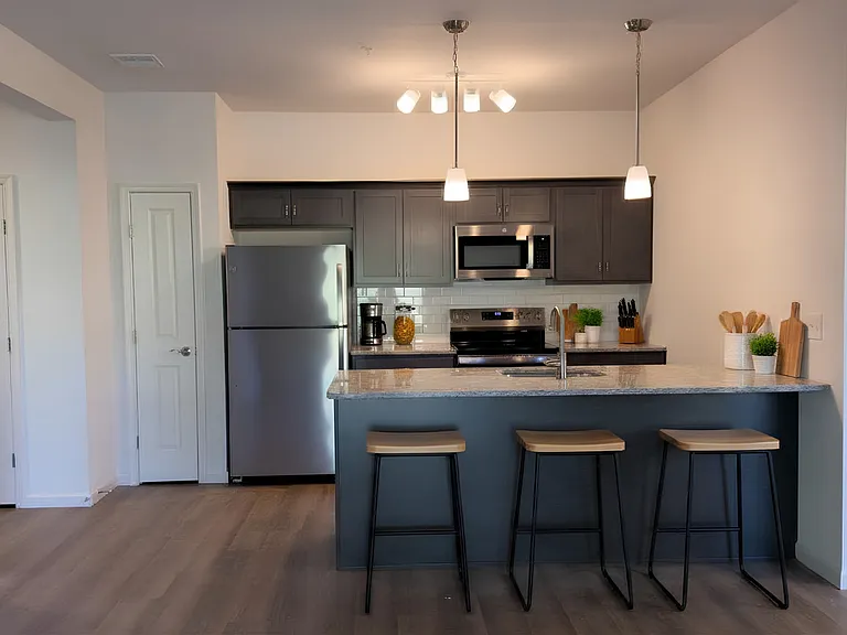 Floor plans feature either a white or dark wood cabinet finishes