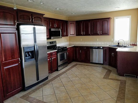 Kitchen with cherry cabinets and stainless steel Kenmore Elite appliances