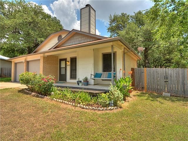 Front garden bed with roses and other flowering plants