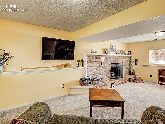 Rec Room In Basement With Cozy Fireplace