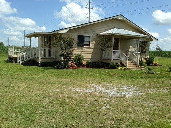 I_m sorry this photo is older. The house was freshly painted then and had landscape. Also the rear deck has been removed