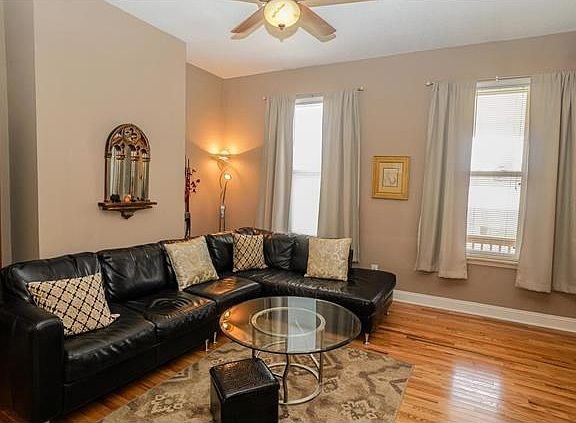 Large living room with ceiling fans throughout home.
