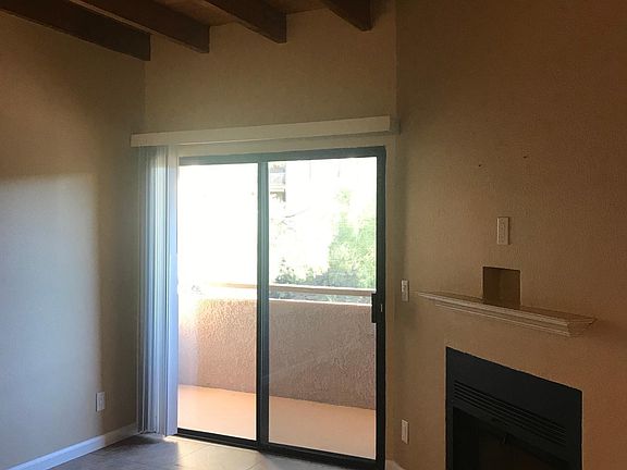 living room with fireplace & private balcony