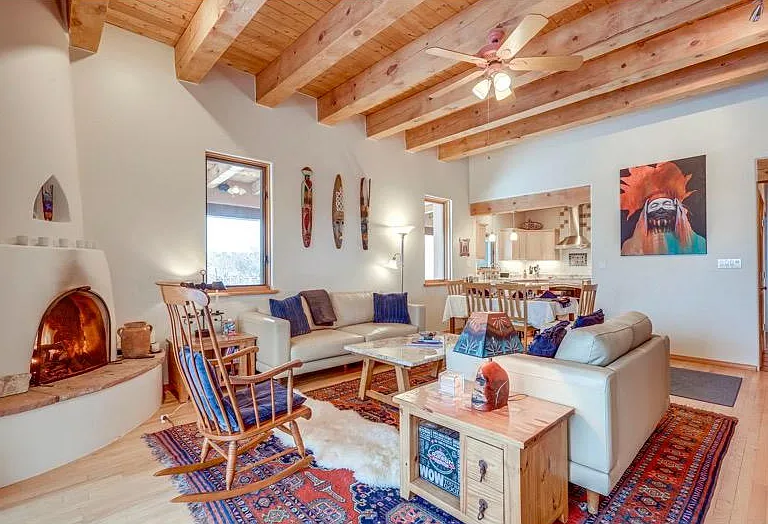 Living room with 12 foot high ceilings and gas kiva fireplace