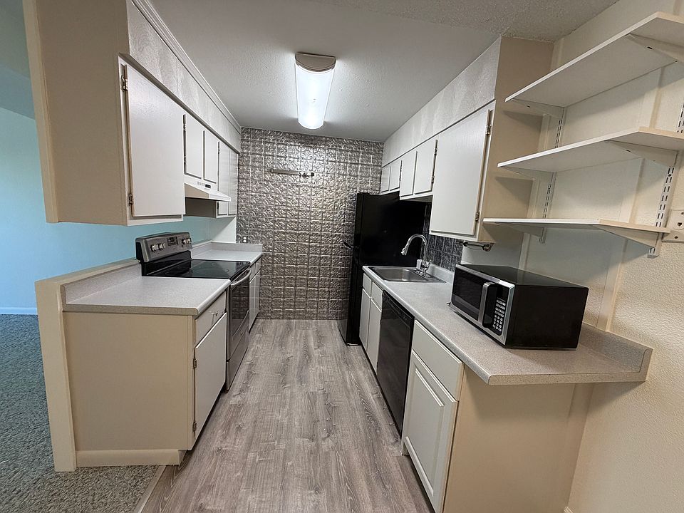 Kitchen with Stove, Oven, Dishwasher & Refrigerator. Freshly painted cabinets, flooring and paint.