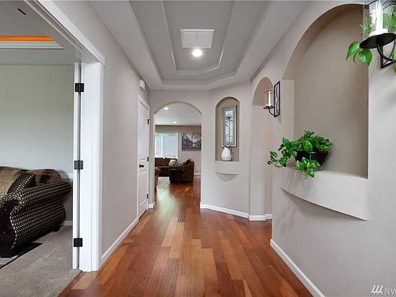 Elegant entry with arched doorways and alcoves