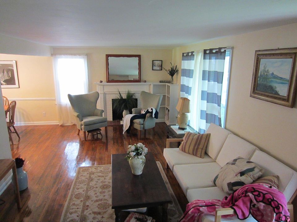 Spacious den with natural light and beautiful hardwoods