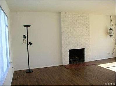 Charming fireplace in living room, see nice refinished wood floo
