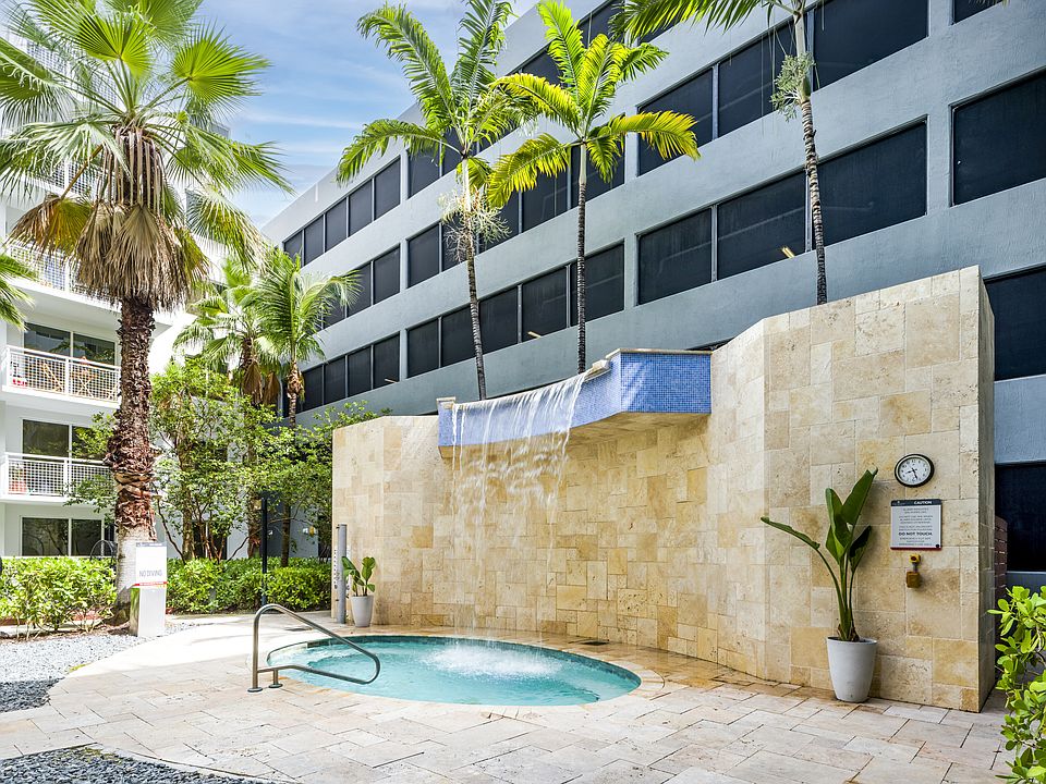 Courtyard Hot Tub With A Serene Water Feature
