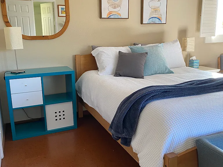 Queen size bed. Cork flooring with area rugs.