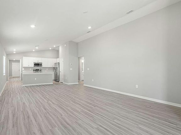 Enjoy a sunny, open-concept living area with volume ceilings - Ashlyn by Highland Homes