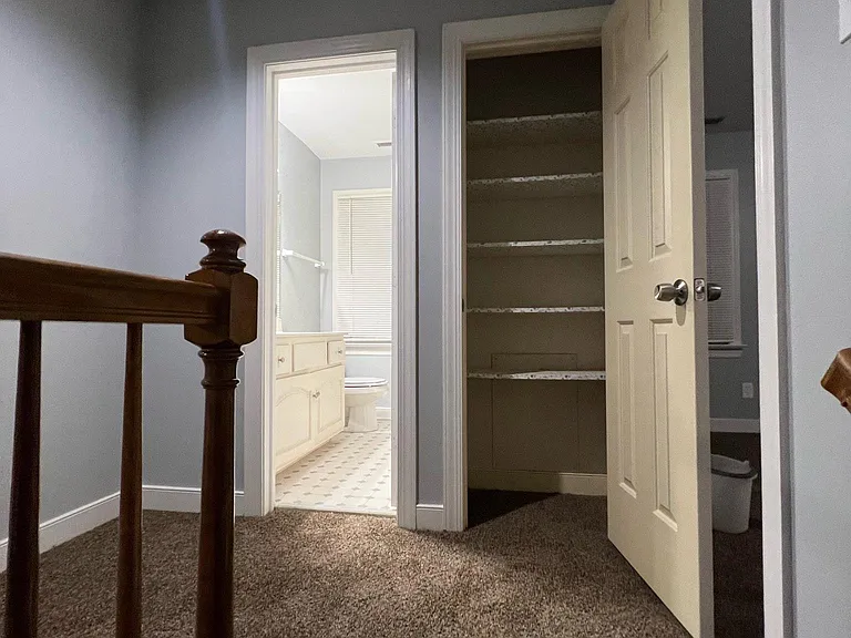 Photo from top of stair, upstairs hall bath and hall closet straight ahead, to the right is the master bedroom