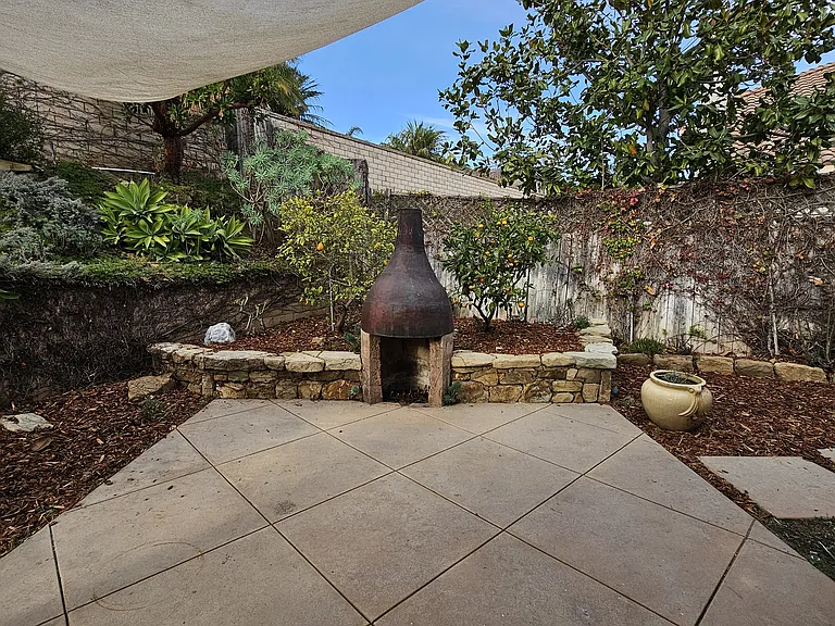 back patio with fruit trees and fireplace