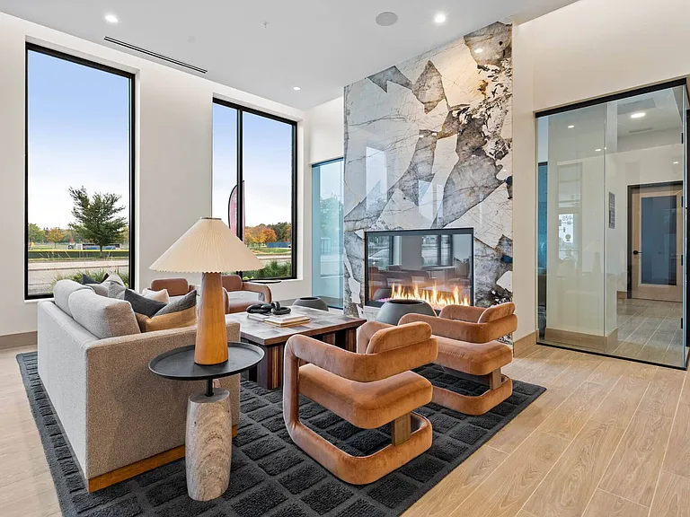 Cozy up by the fire in our community library & lounge at The Hallon Luxury Apartments in Hopkins MN