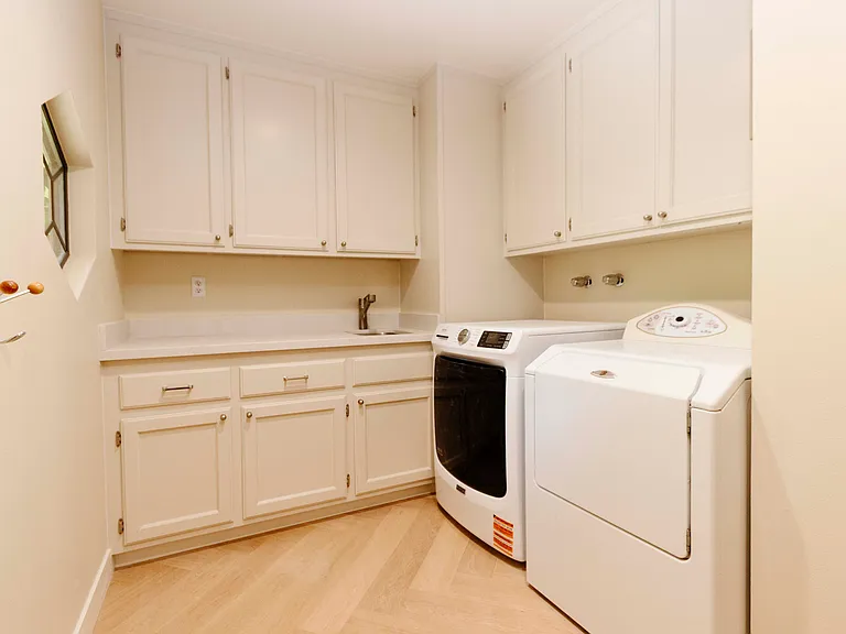 Inside Laundry Room with full size washer and dryer