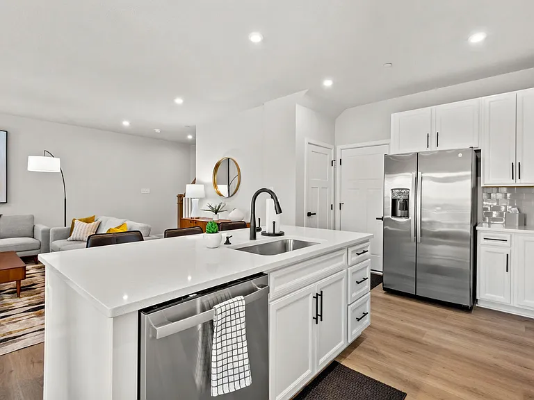 Large center island with quartz counter top provides space for preparation and conversation