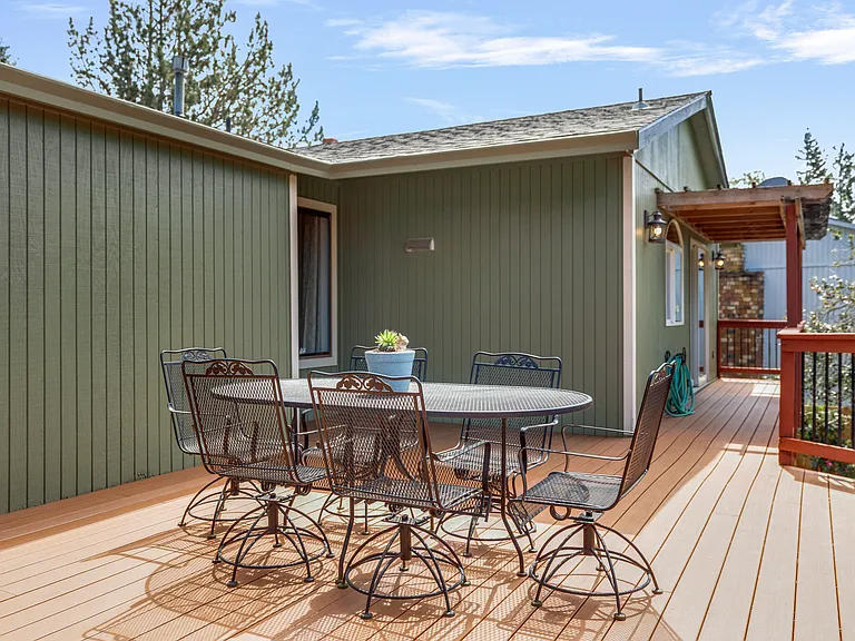 Outside
+Access from kitchen/living room
+Greenhouse (lower right) 
+Dining for 6
+24*20' 
+Trex decking 
+Outdoor lighting 
+1 Ring floodlight camera upstairs by 3rd bdrm door
+2nd Ring floodlight camera located lower level (to the left of the hose)