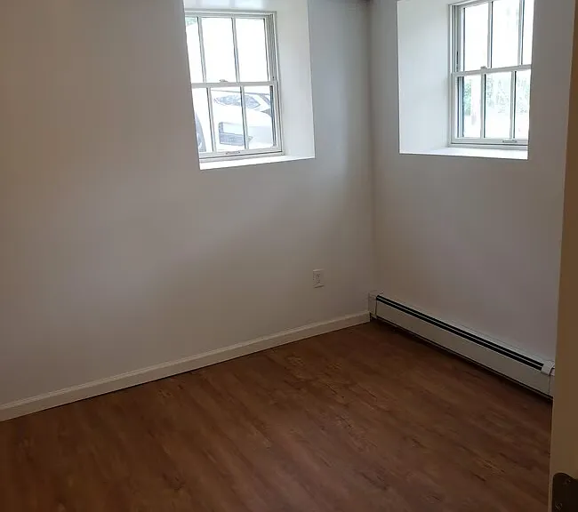Bedroom. Measures approx 15 ft x 10 ft. Two closets. Three windows.