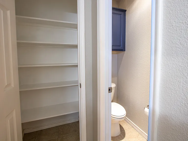 Master bathroom linin closet and toilet