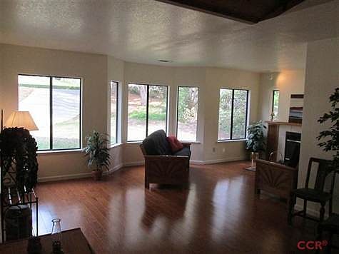 Beautiful Hardwood Floors showcase the living room in front of a real fireplace.