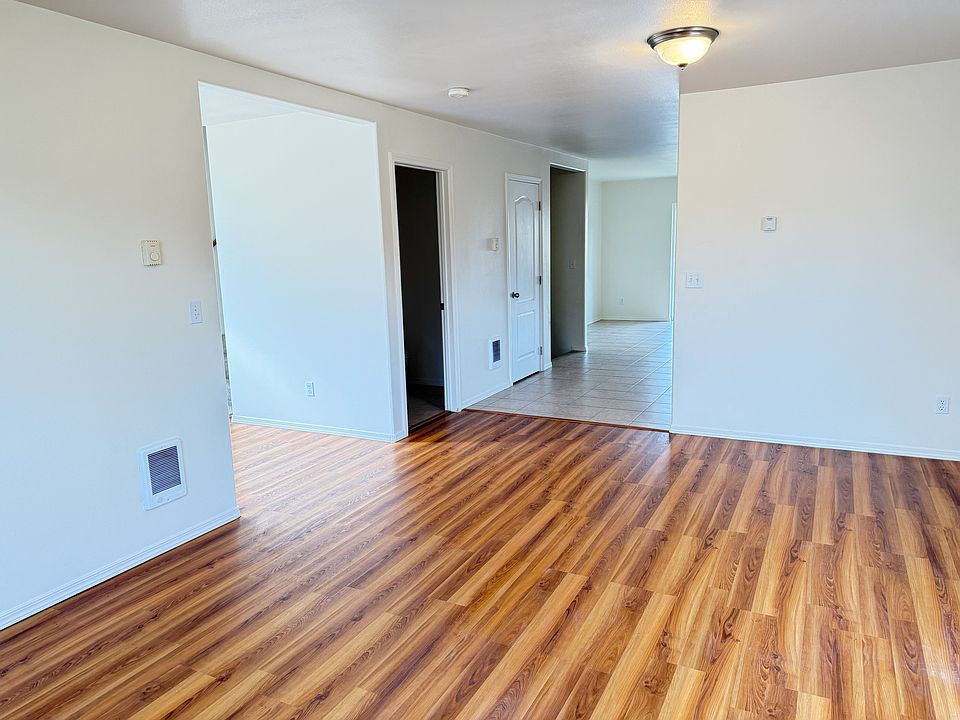 Living room looking towards rear of house to kitchen, dining room, pantry and 1/2 bath.