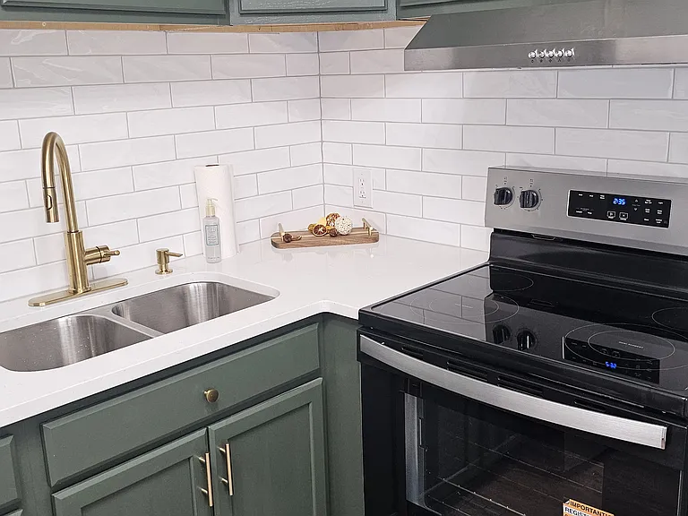 Newly renovated kitchen with new backsplash, flooring, appliances, fixtures and cabinets