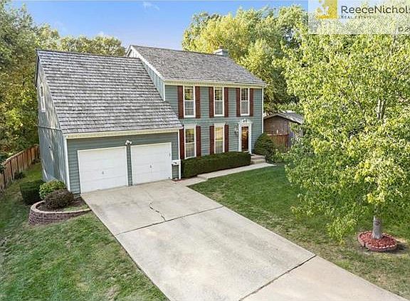 Nestling into the trees, this classic Colonial draws you in.