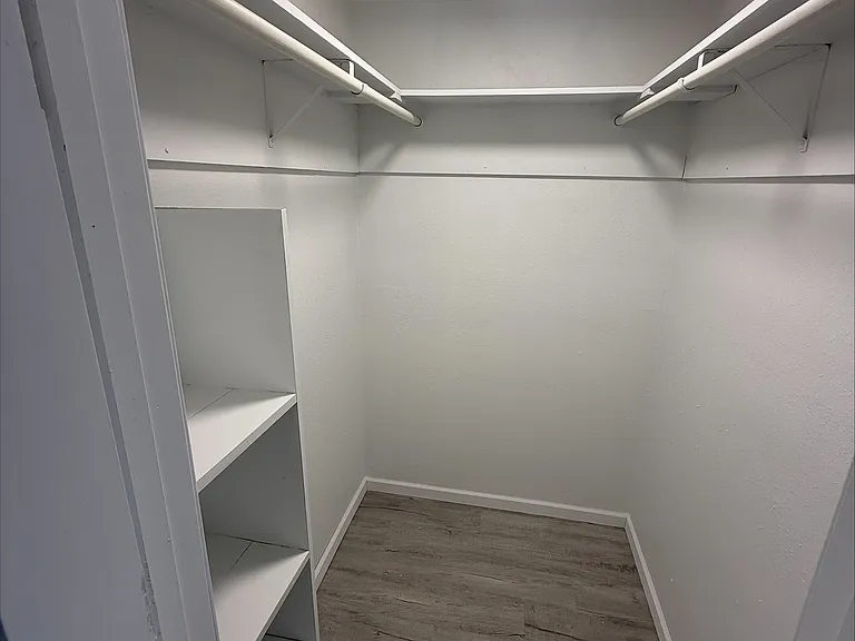 Primary bedroom walk in closet