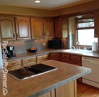 Kitchen : Tumbled marble island and backsplash, Jenn-Air range, convention oven