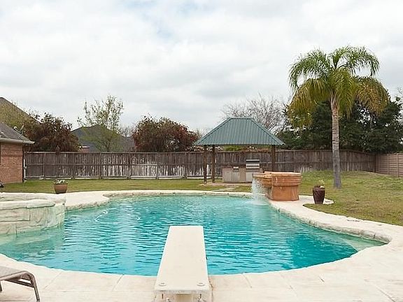 So much to do outdoors!  Heated salt-water pool is 9 1/2 ft deep with diving board.  Outdoor kitchen has grill, double burners, and sink.