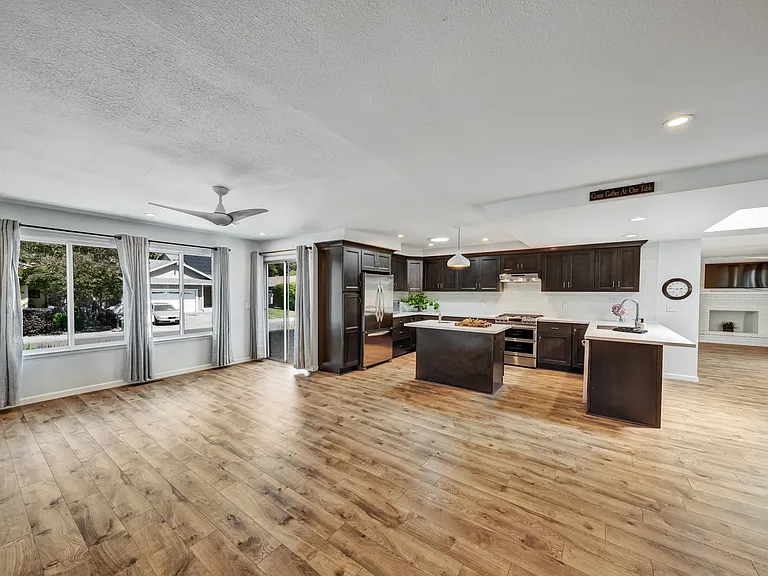 Open concept living room connected to kitchen and dining area and family room.