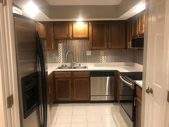 Updated kitchen with cabinet hardware, faucet, and stainless still appliances.
