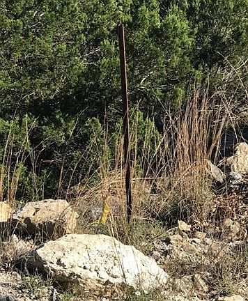 beginning of lot on Scott DR (big stake with little yellow stake next to it)