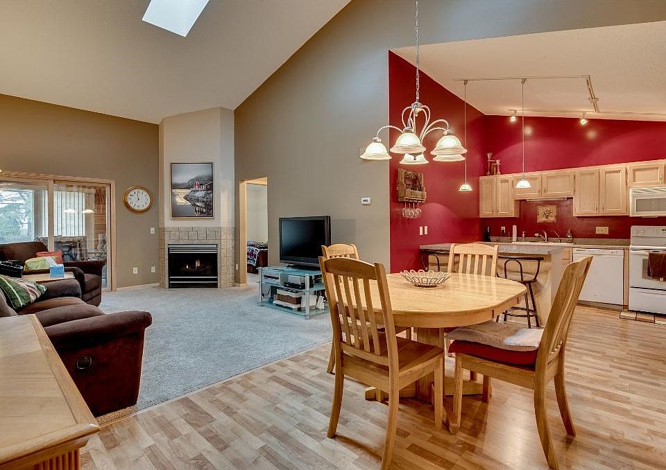 The vaulted ceiling and skylights provide tons of natural light and an open feeling in this living room. A gas fireplace adds to the appeal of this cozy living room.