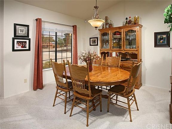 With its large picture window, plush carpet and designer lighting the large formal dining room will easily accommodate any occasion.