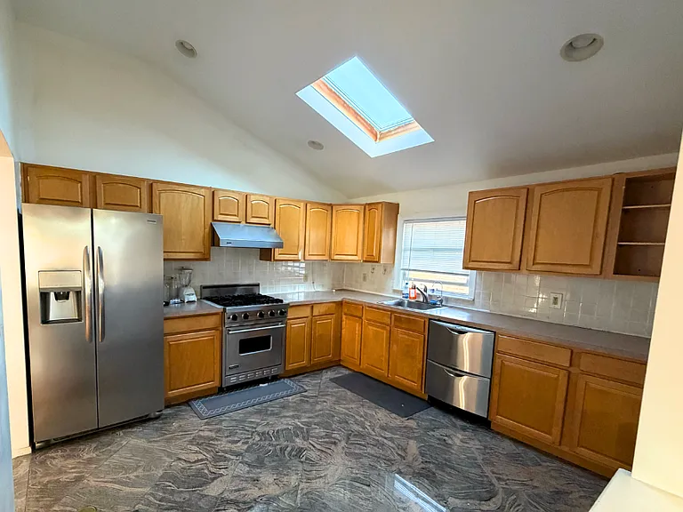 Large eat-in kitchen with skylight and Viking stainless steel appliances