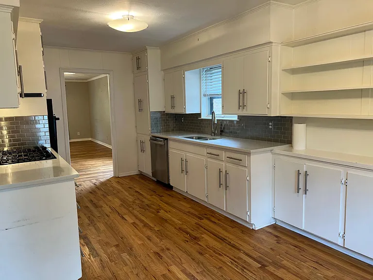 Generous cabinet space, lots of open shelving, with enough room for a table in the breakfast room. There's even a ceiling fan to cool down while cooking.
